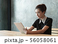 Beautiful asian woman working with tablet. 56058061