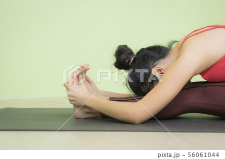 Face down Asian woman seated forward bend. 56061044
