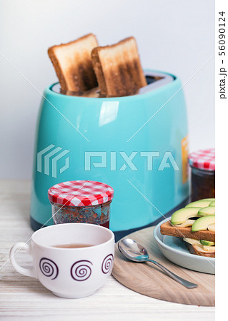 cyan color toaster on a wooden background 56090124