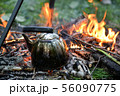 old shiny metal kettle basks on a fire, travel 56090775