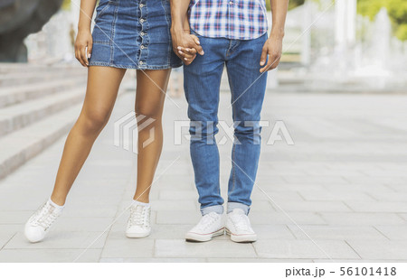 Romantic couple holding hands while walking in the city Romantic couple holding hands while walking in the city 56101418