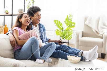 Watching Comedy Movie. Loving Teenage Couple Resting On Sofa 56104609