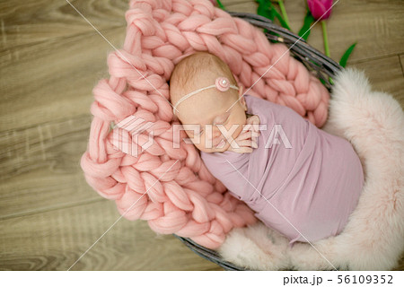 newborn baby girl in pink blanket in a basket newborn baby girl in pink blanket in a basket 56109352
