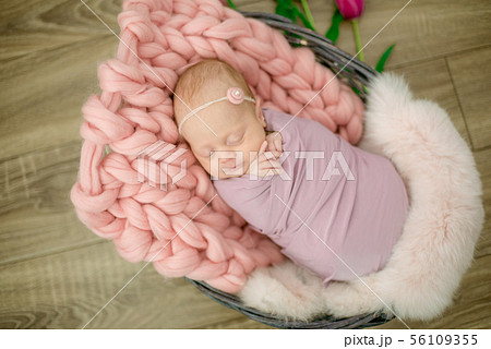 newborn baby girl in pink blanket in a basket newborn baby girl in pink blanket in a basket 56109355