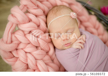 newborn baby girl in pink blanket in a basket newborn baby girl in pink blanket in a basket 56109372