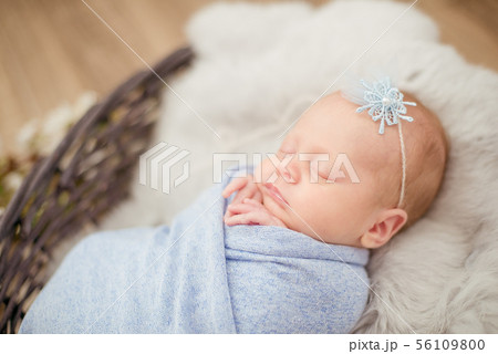 newborn baby girl in blue blanket in a basket newborn baby girl in blue blanket in a basket 56109800