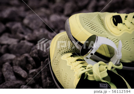 Sport watch for triathlon on yellow running shoes 56112594
