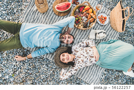 Young couple lying on blanket, smiling and 56122257