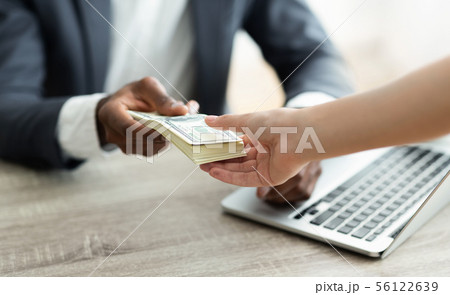Company leader giving money bonus to office worker 56122639