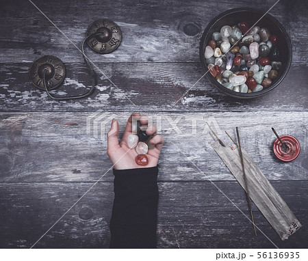 Hand holding small stones in energy healing  56136935