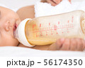 Sleeping newborn girl on bed in bedroom with 56174350