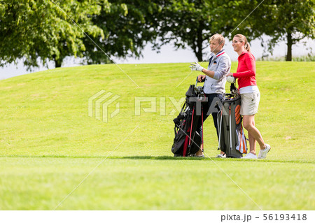 Golfing couple at golf field 56193418