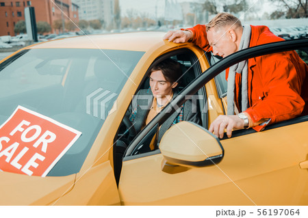 Father choosing a new car for his son. Father choosing a new car for his son. 56197064
