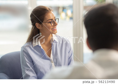 Cute longhaired office worker looking aside at partner Cute longhaired office worker looking aside at partner 56213490