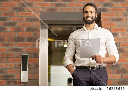Cheerful bearded male person looking for his colleagues 56213636