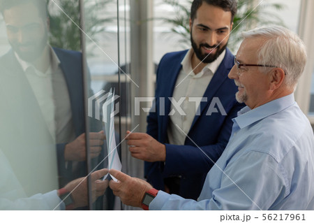 Kind grey-haired male demonstrating his business plan Kind grey-haired male demonstrating his business plan 56217961