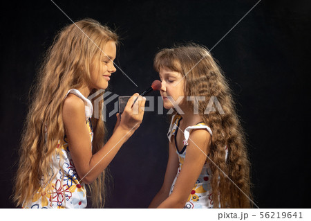 Older sister powders nose to younger sister Older sister powders nose to younger sister 56219641