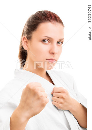 Young girl with the fists up isolated on white 56230741