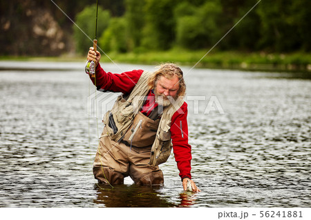Flyfishing in river by mature fisherman. 56241881