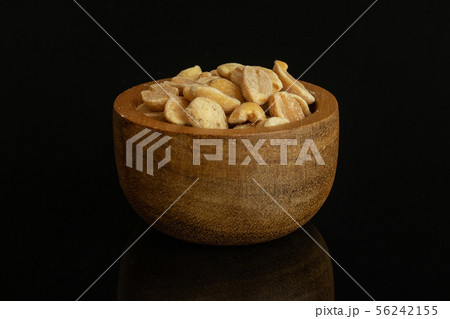 Yellow natural peanut isolated on black glass 56242155