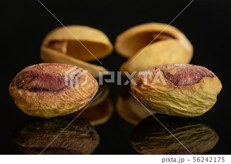 Green salted pistachio isolated on black glass 56242175