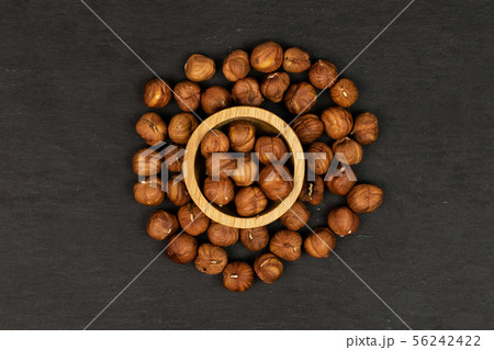 Ripe brown hazelnut on grey stone Ripe brown hazelnut on grey stone 56242422
