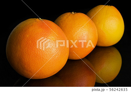 Fresh pink grapefruit isolated on black glass Fresh pink grapefruit isolated on black glass 56242635