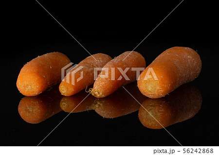 Orange baby carrot isolated on black glass Orange baby carrot isolated on black glass 56242868