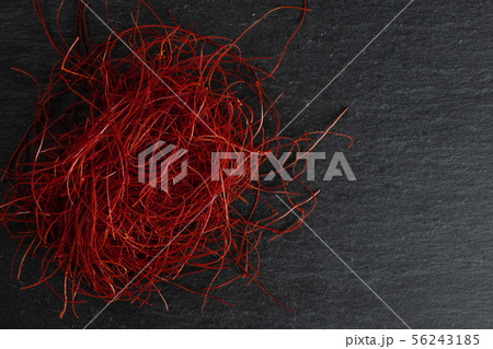 Red chili threads on grey stone Red chili threads on grey stone 56243185