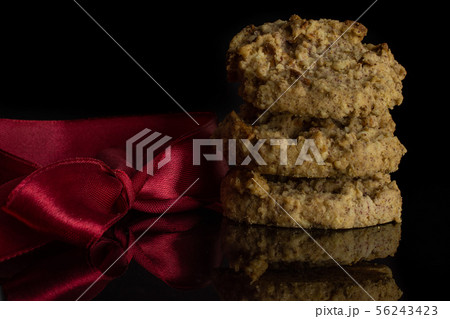 Oat crumble biscuit isolated on black glass Oat crumble biscuit isolated on black glass 56243423