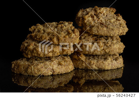 Oat crumble biscuit isolated on black glass 56243427
