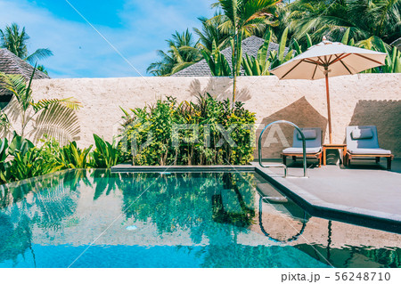 Umbrella and chair around swimming pool neary sea ocean beach with blue sky and white cloud Umbrella and chair around swimming pool neary sea ocean beach with blue sky and white cloud 56248710