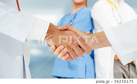 Doctor working in hospital with other doctors. 56250175