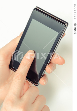 Hand of woman holding mobile phone 56253226