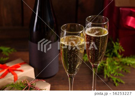 Christmas holiday table with glasses and a bottle Christmas holiday table with glasses and a bottle 56253227