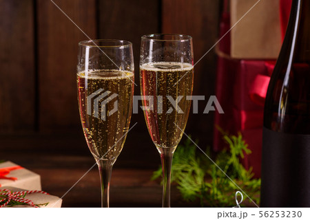 Christmas holiday table with glasses and a bottle Christmas holiday table with glasses and a bottle 56253230