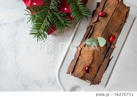Bush de Noel Christmas Log Cake and New Year background. Copy space. Bush de Noel Christmas Log Cake and New Year background. Copy space. 56270751