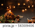 Christmas composition - decorative candle, Christmas tree branches and decorations on a dark 56309406