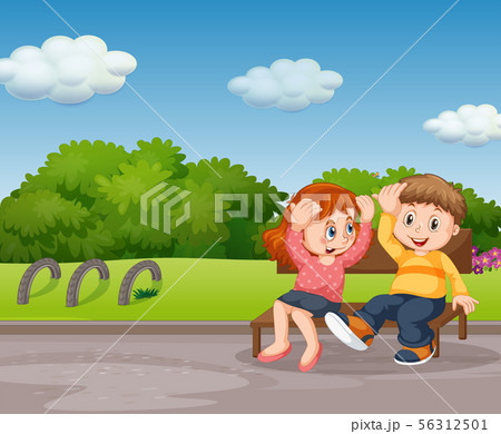 Boy and girl sitting in park 56312501