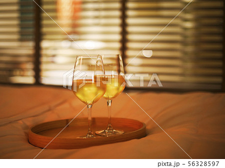 Two glasses of white wine in bed on the blurred Two glasses of white wine in bed on the blurred 56328597