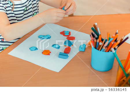Top view of blue plasticine pieces on paper Top view of blue plasticine pieces on paper 56336145