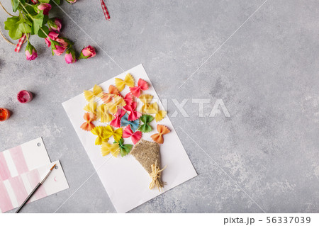 Paper crafts for mother day, 8 march or birthday. Small child doing a bouquet of flowers out of 56337039
