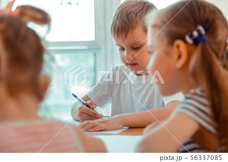 Nice diligent boy looking at the drawing 56337085