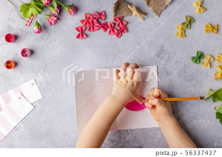 Paper crafts for mother day, 8 march or birthday. Small child doing a bouquet of flowers out of 56337437