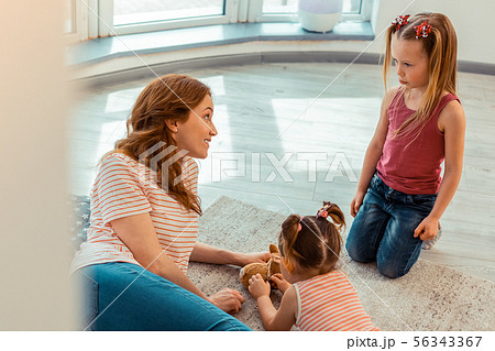 Positive friendly woman looking at the girl 56343367
