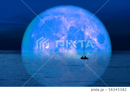 reflection full harvest moon on sky and silhouette 56345382