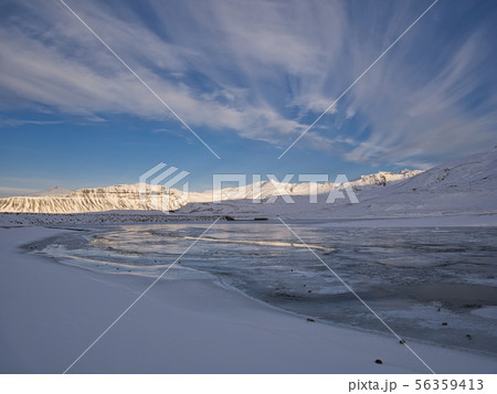 Beautiful winter landscape with lake and clouds Beautiful winter landscape with lake and clouds 56359413