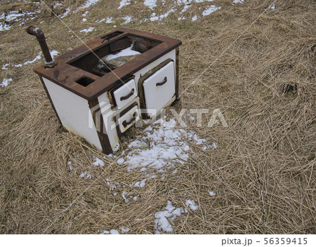 An antique kitchen stove outside on a meadow 56359415