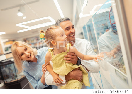 Girl while visiting aquarium with mommy and daddy 56368434
