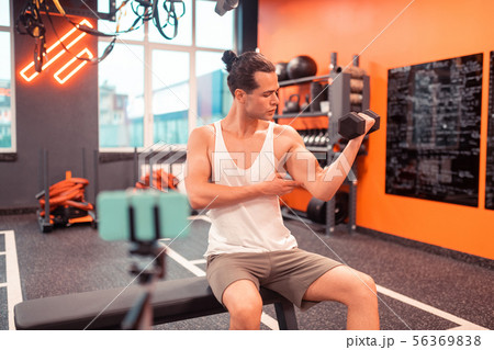 Fit well built man showing his muscular arm 56369838